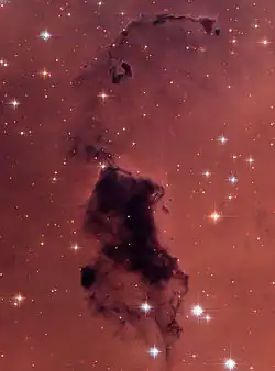 Bok globule in NGC 281 near the star cluster IC 1590. Image by the Hubble Space Telescope.