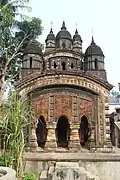 Joypur: De para nava ratna temple (in picture), Dutta para nava ratna temple and deul and atchala temples, all with rich terracotta decoration. There is an inscription on the wall of that nava ratna temple of De para ,which indicates the establishment year of that temple‌ ,which was 16thJanuary in the year of 1844, In this temple,the Janardhana as well as lord Krishna is worshipped by de family till now,*.