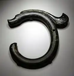 A C-shaped jade object with a dragon head