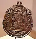 A nightwatchman's pass of the Mongol empire, with inscriptions in Persian (left), Mongolian in 'Phags-pa script (centre), and Uyghur (right). The Mongolian inscription reads "Announcement: Beware of evil-doers".