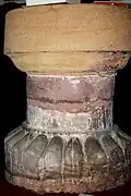 Inverted Saxon baptismal font supporting upright Norman font