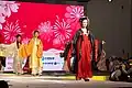 Woman wearing a long, yellow bijia (middle), 2020.