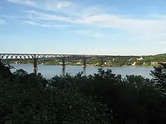 Walkway over the Hudson with the City of Poughkeepsie in the background and the Hudson River in the foreground.