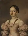 Portrait of a girl wearing a black headband and a necklace made of human hair.