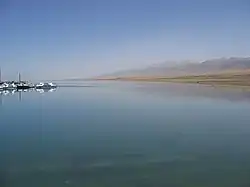 Lake with some boats and a mountain in the background