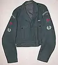 No.2 Battledress blouse, (RAF 1947 pattern), showing medal ribbon bar and plastic Beacon Lighter buttons. Sleeves: Shoulder flash, Group numeral, Red "Spitfire" proficiency and Leading Observer badges.