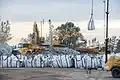 Rock being loaded into bags for transport by helicopter (upper right) to reinforce the emergency spillway (February 13)