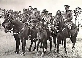 A group of five senior military personnel on horseback.