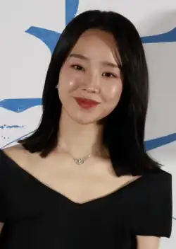 Shin in a black dress posing for the camera in 2024