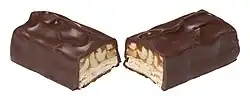 A Snickers chocolate bar covered in dark chocolate