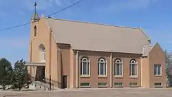 Brick church with four round-topped windows along side