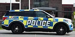 A Ford Explorer police cruiser with yellow-and-blue Battenburg markings in St. Thomas, Ontario.