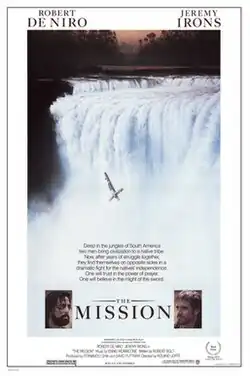 A man, seen crucified, falls into a waterfall. Text reads "Deep in the jungles of South America two men bring civilization to a native tribe. Now, after years of struggle together, they find themselves on opposite sides in a dramatic fight for the natives' independence. One will trust in the power of prayer. One will believe in the might of the sword." Images of Robert De Nior and Jeremy Irons in their roles are below the image followed by additional credits.
