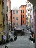 The troughs of Santa Brigida (photographed from Via Balbi): they were built in 1656, during the plague that hit the city hard, with contributions from the Balbi family.[210] The area, like much of the historic center, which was neglected during the second half of the 20th century, has been accessible again since 2006, after heavy restorations led to its almost complete closure for about 20 years.[211] The square, with its characteristic appearance, is one of the recurring locations in films shot in Genoa in the second half of the 20th century.[212]