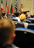 At NMIOTC, U.S. Navy Capt. Bradley D. Martin addresses a multinational audience during a pre-sail conference for exercise Phoenix Express 2012, a two-week exercise designed to strengthen maritime cooperation among partners from Africa, Europe and United States.