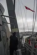 A courtesy Turkish flag is raised aboard the destroyer USS Truxtun as the ship transits the Bosphorus Strait