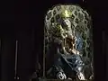 Wooden statue of the Virgin with baby Jesus standing on her knees