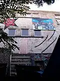 The face of the squat 'Villa Squattus Dei [nl]' in Leuven (Belgium). Also depicted: caricature of Louis Tobback.