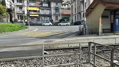 Platform shelter on a platform with a railway line next to road