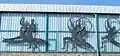 Parts of the copper artwork Sport-Fries at the facade of the large sports halls complex .