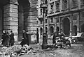 Starving citizens taking meat from the remains of dead horses on Nowy Świat Street near the intersection with Staszic Palace