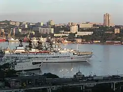 Ships in port, with modern buildings in the background