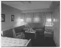 First-class cabin U 141, showing mid-century modern furnishings and the lack of detail common throughout the ship. Not shown is the cabin's private bath.[30]